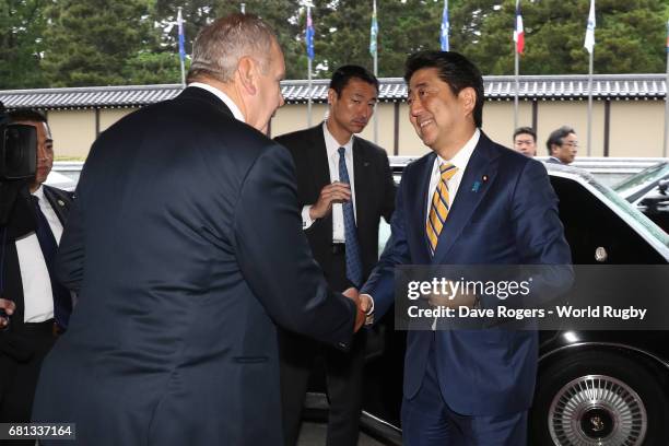 Shinzo Abe, Prime Minister of Japan is greeted upon arrival by Bill Beaumont, Chairman of World Rugby via Getty Images during the Rugby World Cup...