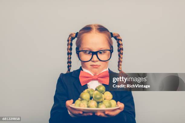 young girl nerd with brussels sprouts - brussel sprout stock pictures, royalty-free photos & images