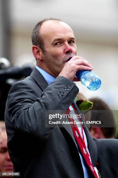 England coach Clive Woodward takes a drink as he soaks up the atmosphere of the day