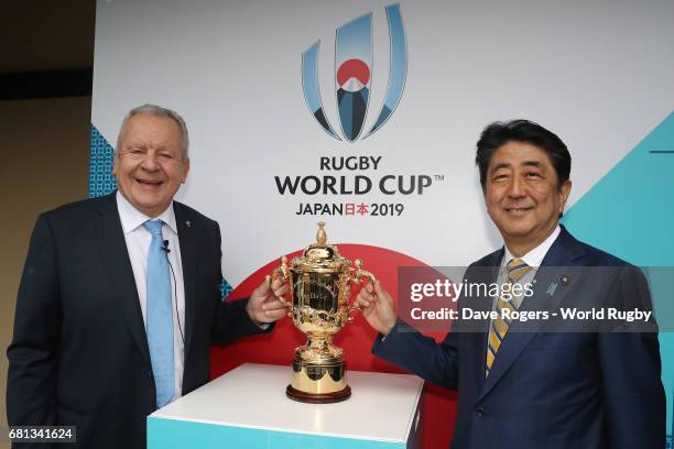 Bill Beaumont, Chairman of World Rugby via Getty Images and Shinzo Abe, Prime Minister of Japan pose with The William Webb Ellis Cup during the Rugby...