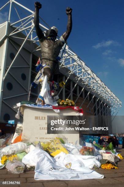 Fans lays flowers at the Billy Bremner statue in memory of ex Leeds United player John Charles