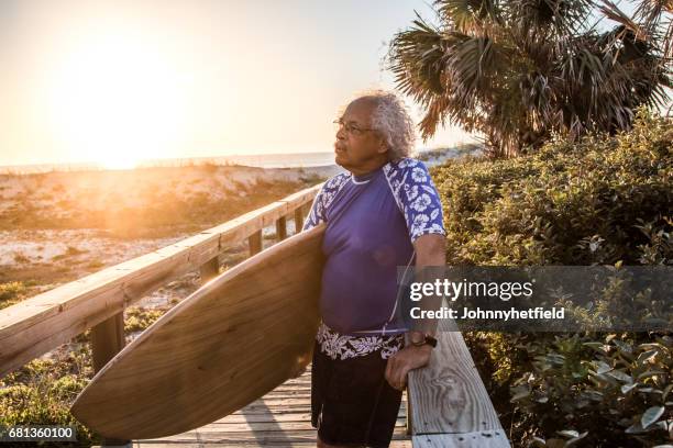 portrait of a mature surfer at sunrise - portrait lens flare stock pictures, royalty-free photos & images