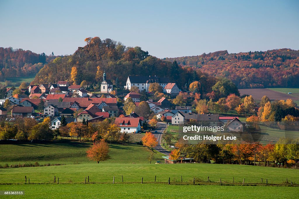 Haselstein village and trees with autumn foliage