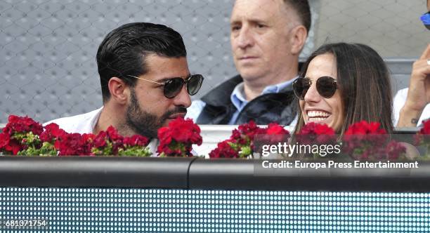 Football player Miguel Torres and Lucia Villalon attend a match during day two of the Mutua Madrid Open tennis tournament at La Caja Magica on May 9,...