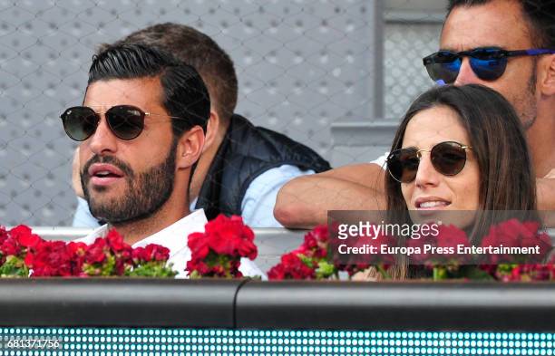 Football player Miguel Torres and Lucia Villalon attend a match during day two of the Mutua Madrid Open tennis tournament at La Caja Magica on May 9,...