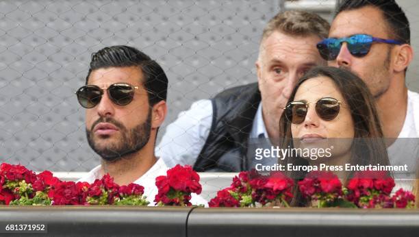 Football player Miguel Torres and Lucia Villalon attend a match during day two of the Mutua Madrid Open tennis tournament at La Caja Magica on May 9,...