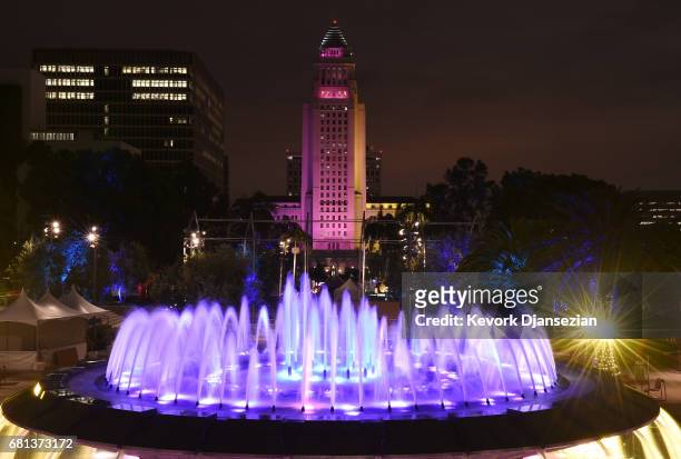 More than a dozen landmark buildings and tourist sites which includes Los Angeles City Hall and the fountain in Grand Park, is illuminated in the...