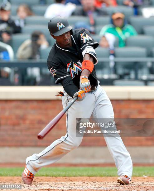 Adeiny Hechavarria of the Miami Marlins hits a ground ball in an MLB baseball game against the New York Mets on May 7, 2017 at CitiField in the...