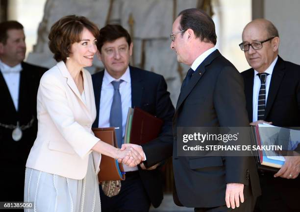 French President Francois Hollande shakes hands with French Minister for Social Affairs and Health Marisol Touraine, at the end of their last weekly...