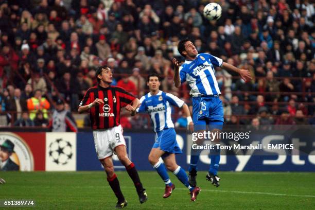 Deportivo La Coruna's Joan Capdevila wins a header over AC Milan's Filippo Inzaghi