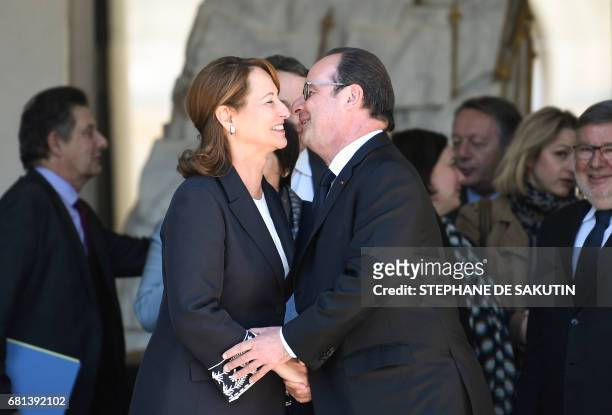 French President Francois Hollande shakes hands with French Minister for Ecology, Sustainable Development and Energy Segolene Royal, at the end of...