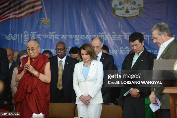 Tibetan Spiritual leader the Dalai Lama and Democratic leader of the US House of Representatives Nancy Pelosi stand onstage as they prepare to...