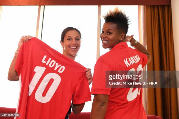 Legends Karina LeBlanc of Canada and Carli Lloyd of USA pose with Bahrain National team shirts presented to them by the Bahrain Women's National team...