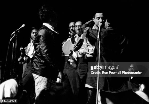 Smokey Robinson and the Miracles perform as a couple of fans run onstage at Evanston High School in Evanston, Illinois September 1968