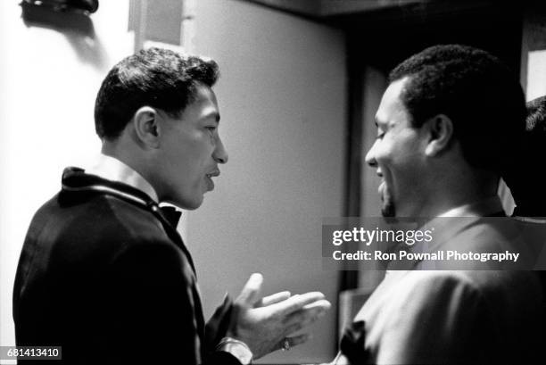 Smokey Robinson talking with one of The Miracles in boys locker room before going onstage at Evanston High School in Evanston, Illinois September 1968