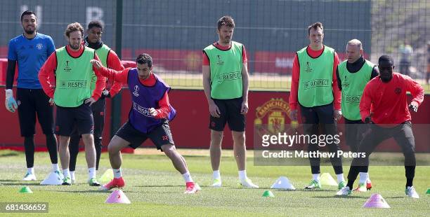 Henrikh Mkhitaryan and Eric Bailly of Manchester United in action during a first team training session at Aon Training Complex on May 10, 2017 in...
