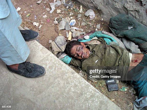 Taliban fighter lies dead by the side of the road November 12, 2001 in Kabul, Afghanistan. Opposition fighters captured Afghanistan's capital in...