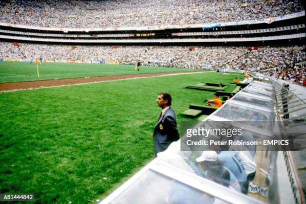 Argentina Coach Carlos Bilardo watches the match from in front of the dugout