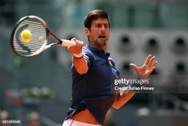 Novak Djokovic of Serbia plays a forehand in his match against Nicolas Almagro of Spain during day five of the Mutua Madrid Open tennis at La Caja...