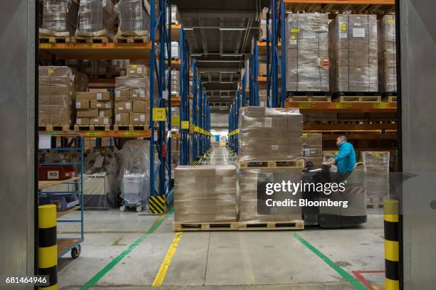 An employee transports a pallet of pharmaceutical products on a forklift truck inside the Nippon Yusen K.K. Pharma distribution center at the Port of...