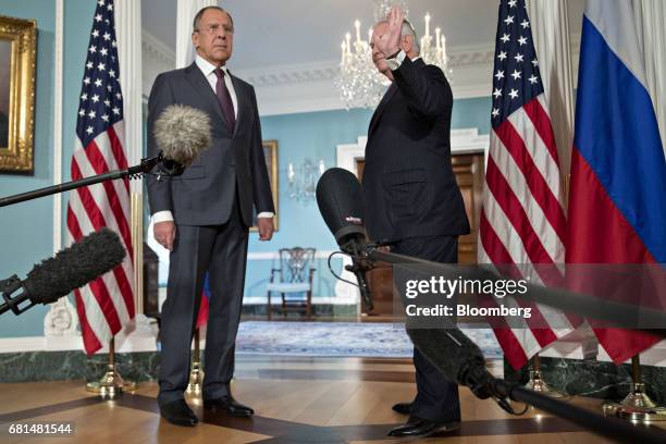 Sergei Lavrov, Russia's foreign minister, left, stands as Rex Tillerson, U.S. Secretary of State, waves during a photo opportunity at the U.S...