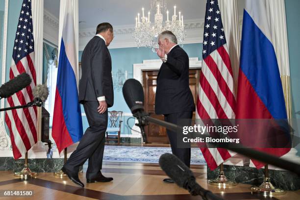 Sergei Lavrov, Russia's foreign minister, left, walks out as as Rex Tillerson, U.S. Secretary of State, waves during a photo opportunity at the U.S...
