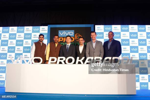 Indian Kabaddi players Rahul Chaudhari, Anup Kumar pose with Kent Cheng, CEO, Vivo India, Sanjay Gupta, Managing Director, Star India and former...