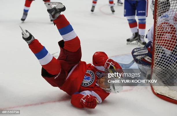 Russian President Vladimir Putin falls down during the 'Night League' teams ice hockey Gala match at the Shayba Olympic Arena in Sochi on May 10,...