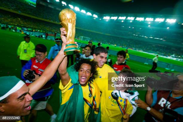 Denilson, Ronaldinho, Juninho Paulista and Luizao of Brazil celebrate his victory with the World Cup Trophy during the World Cup Final match between...