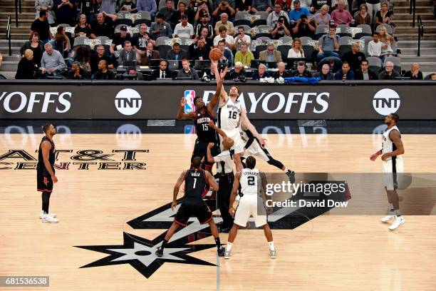 Clint Capela of the Houston Rockets and Pau Gasol of the San Antonio Spurs go up for the opening tip off before Game Five of the Western Conference...