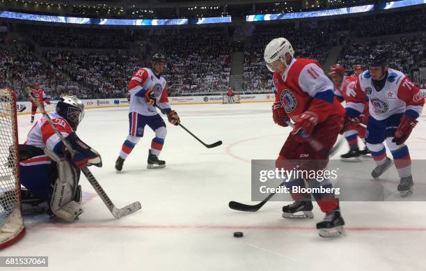 Vladimir Putin, Russia's president, right, plays a gala ice hockey match in the night hockey league in Sochi, Russia, on Wednesday, May 10, 2017. The...