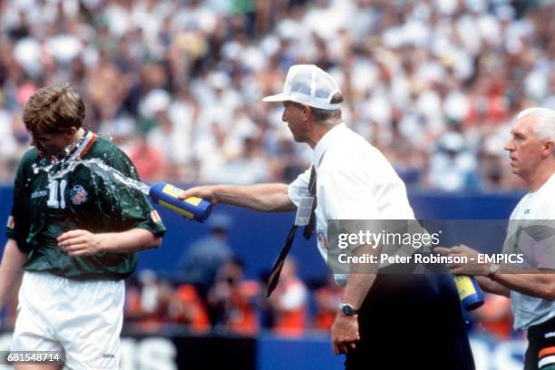 Ireland manager Jack Charlton throws water onto Steve Staunton to cool him down in the intense Florida heat