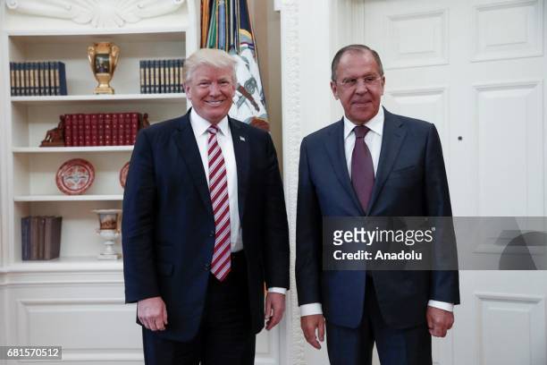 President Donald Trump and Russia's Foreign Minister Sergei Lavrov pose for a photo as they meet at the Oval Office of White House in Washington,...
