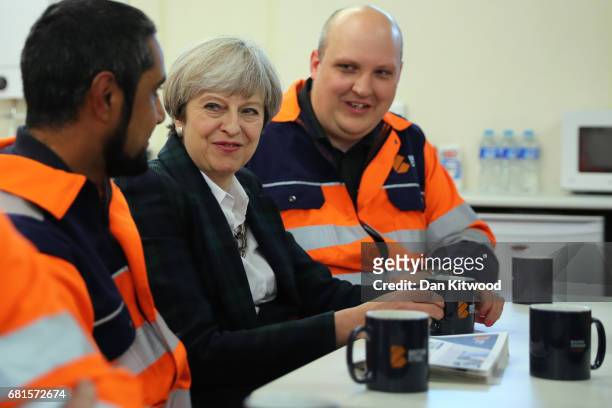 British Prime Minister Theresa May talks to staff in a tea room at British Steel as she campaigns in North Lincolnshire on May 10, 2017 in...