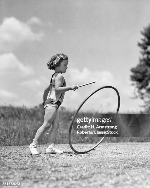 1930s GIRL OUTDOORS ROLLING A HOOP PLAYING HOOP AND STICK GAME
