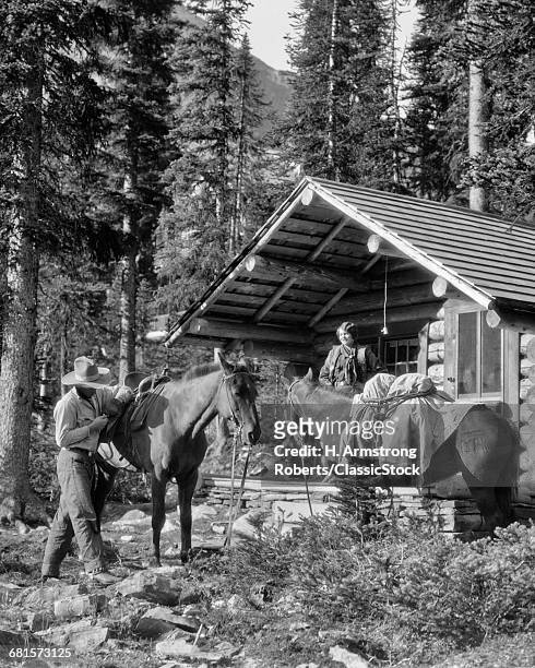 1920s CAMPING WOMAN STANDING PORCH LOG CABIN MAN PUTTING SADDLE ON HORSE LAKE OHARA BRITISH COLUMBIA CANADA