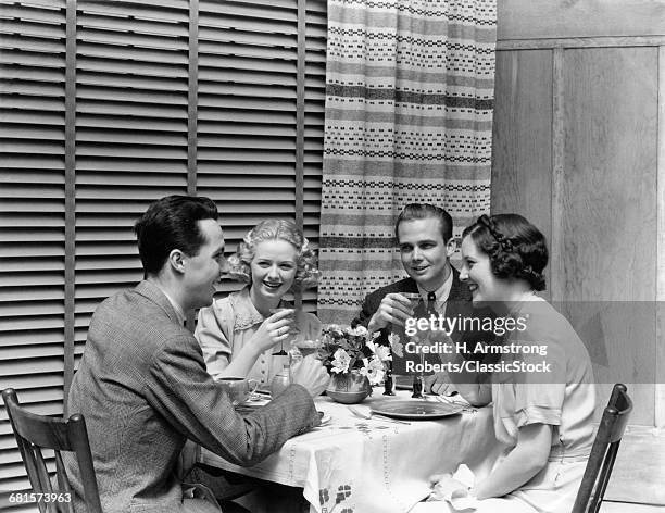 1930s 1940s TWO COUPLES MAN WOMAN AT DINING TABLE HAVING COCKTAILS TOASTING RESTAURANT VENETIAN BLINDS CURTAINS