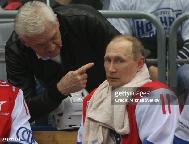 Russian President Vladimir Putin listens to billionaire and businessman Gennady Timchenko during a gala match of the Night Hockey League teams at the...