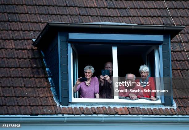 Spectators watch from a window during a CDU campaign rally ahead of state elections in North Rhine-Westphalia on May 10, 2017 in Haltern am See,...