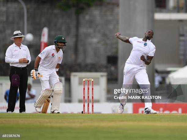 Captain Jason Holder of the West Indies bowls as Babar Azam of Pakistan looks on during the first day of play, of the 3rd and final test match at the...