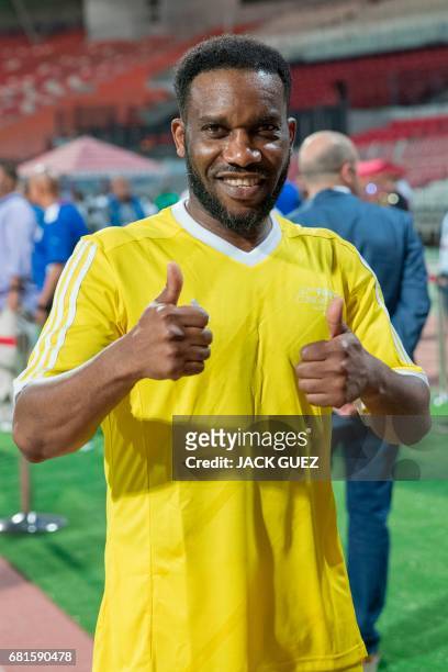 Retired Nigerian football player Jay-Jay Okocha poses for a photograph during the opening ceremony of a FIFA Legends football game on May 10, 2017 in...