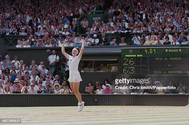 Swiss tennis player Martina Hingis throws her arms in the air in celebration after beating Czech tennis player Jana Novotna, 2-6, 6-3, 6-3 in the...