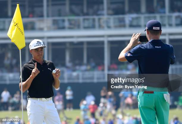 Rickie Fowler poses for a picture with Justin Thomas after making a hole-in-one on the 17th hole during previews prior to the start of THE PLAYERS...