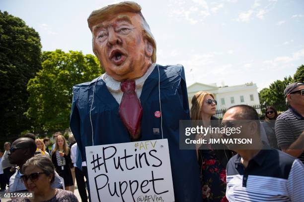 Protester wears an effigy of Donald Trump in front of the White House during a protest demanding an independent investigation in the Trump/Russia...