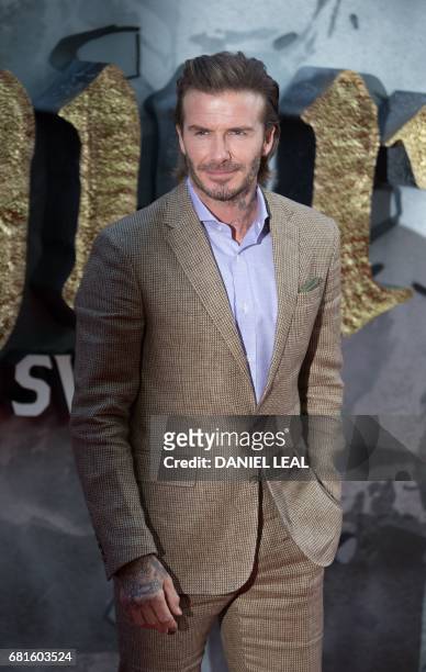Former England football captain David Beckham poses for a photograph upon arrival at the European Premiere of "King Arthur: legend of the Sword" in...