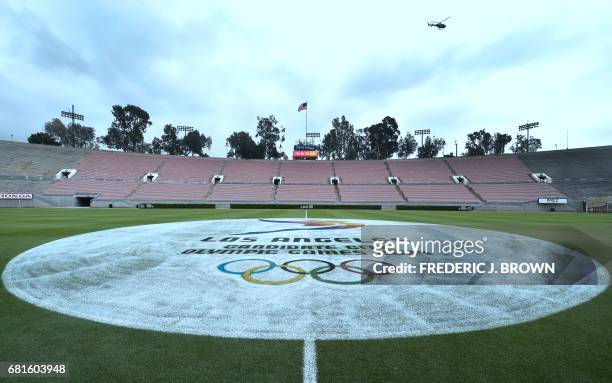 Helicopter flies over the Rose Bowl, decorated with an Olympics logo on the center of the pitch, as journalists are taken on a tour of Olympic venues...