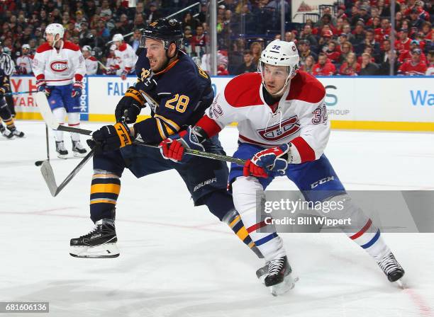 Zemgus Girgensons of the Buffalo Sabres skates against Brian Flynn of the Montreal Canadiens during an NHL game at KeyBank Center on April 5, 2017 in...