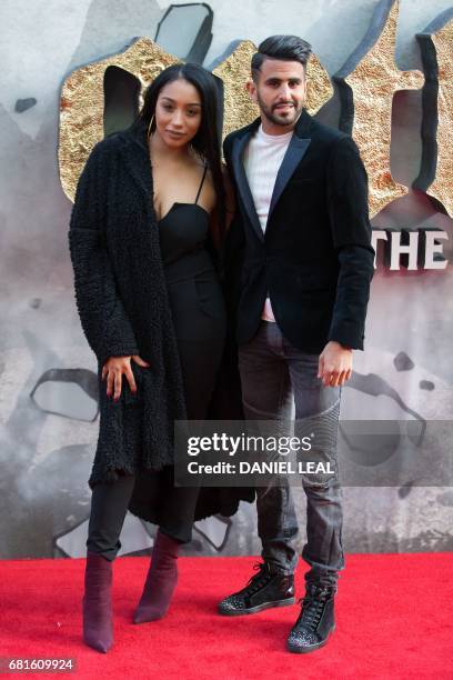 Leicester City footballer Riyad Mahrez and his wife Rita pose for a photograph upon arrival at the European Premiere of "King Arthur: legend of the...