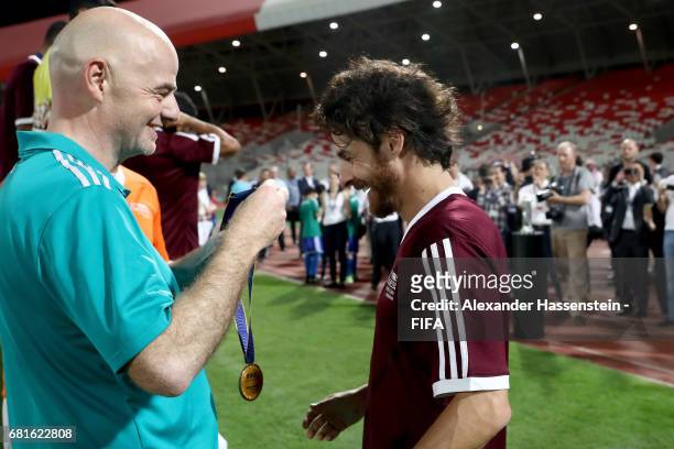 President Gianni Infantino hands over the winners trophy to Pablo Aimar of the Bahrain Football Association after the FIFA Football Tournament ,...