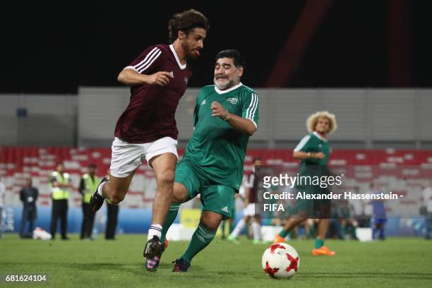 Legend Diego Maradonna of Argentina battles for the ball with FIFA Legend Pablo Aimar of Argentina during a FIFA Football Tournament, ahead of the...
